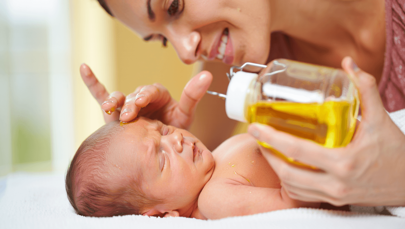 bébé qui se fait masser avec des huiles végétales