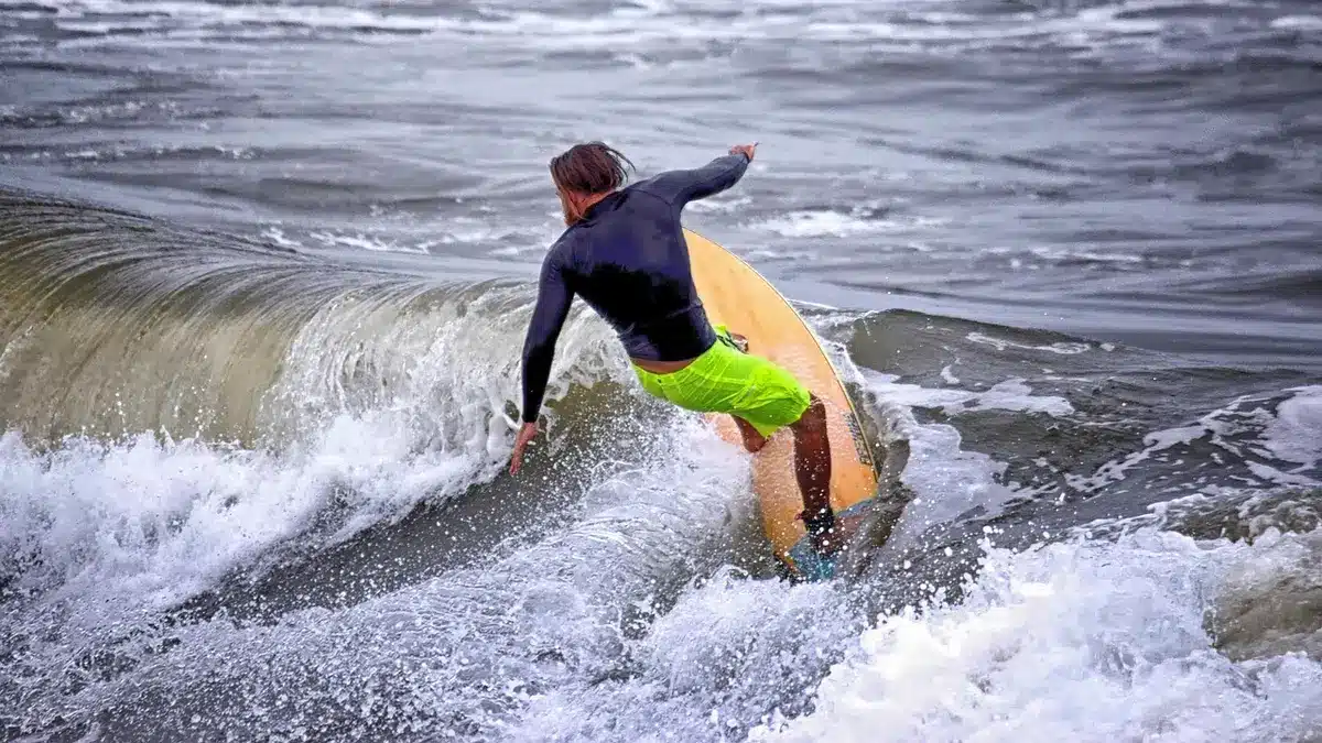Surfeur en action sur une vague de la côte atlantique brésilienne au coucher de soleil